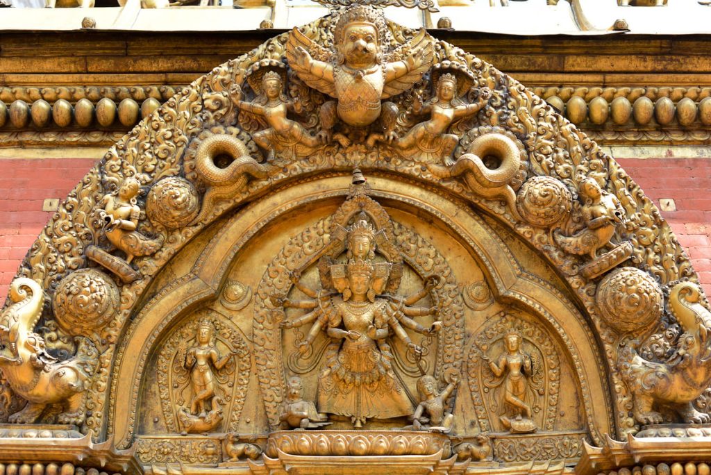 Devi Taleju Bhawani (with 10 arms standing on a lotus) adorns the Golden Gate in Bhaktapur Darbur Square, the main entrance to the Kumari temple. Built in 1753 by King Ranjit Malla.