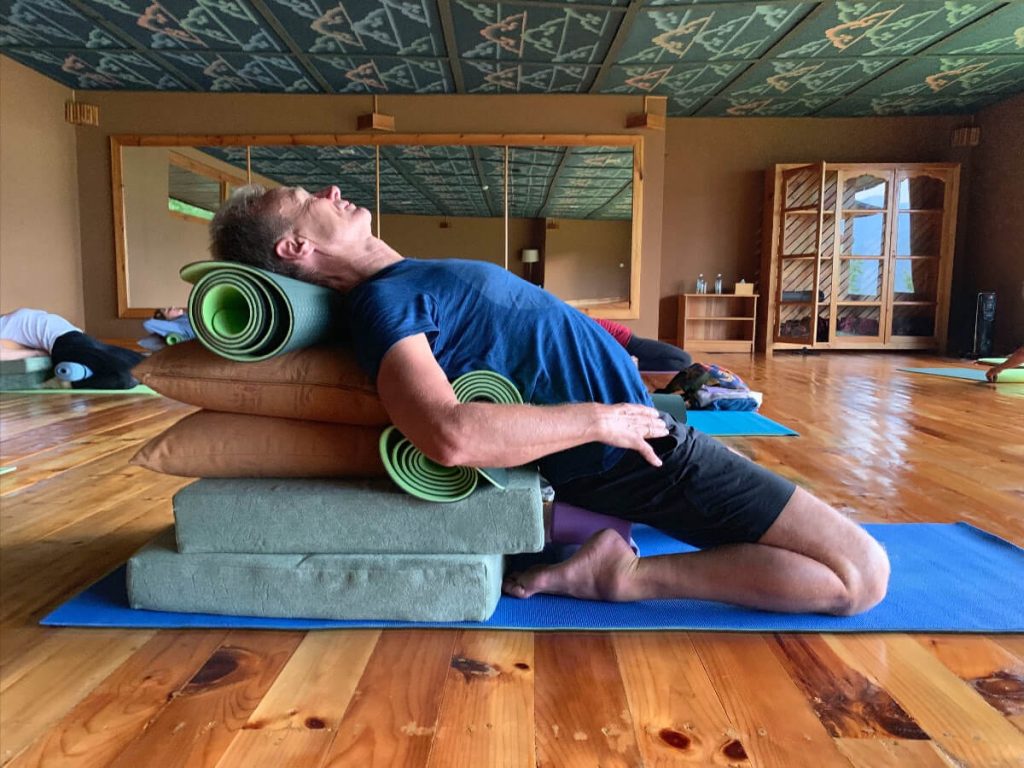 Student on the Bhutan Yoga Adventure in a restorative Supta virasana.