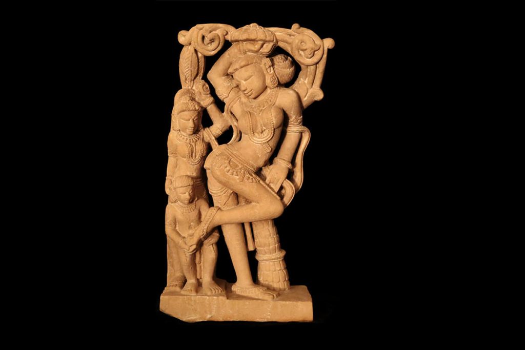 A similar feminine figure that adorns Sanchi and known as a Yaksha.